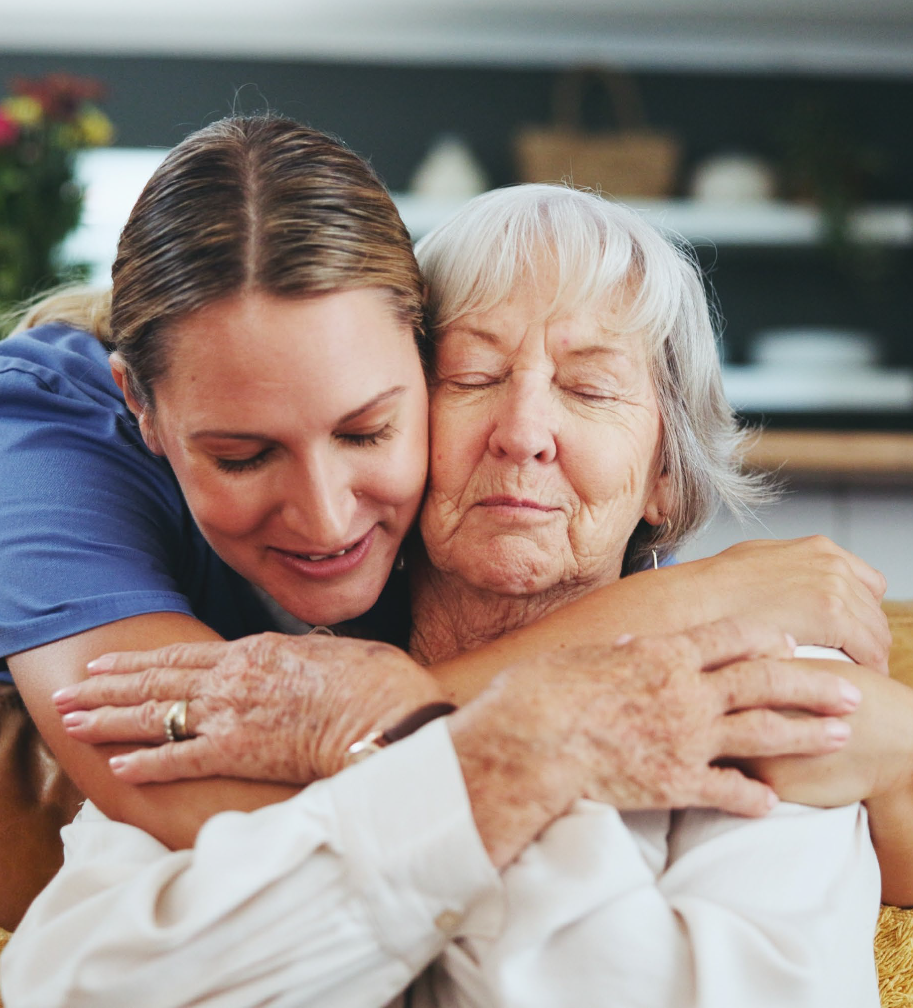 Care home nurse interacting happily with resident