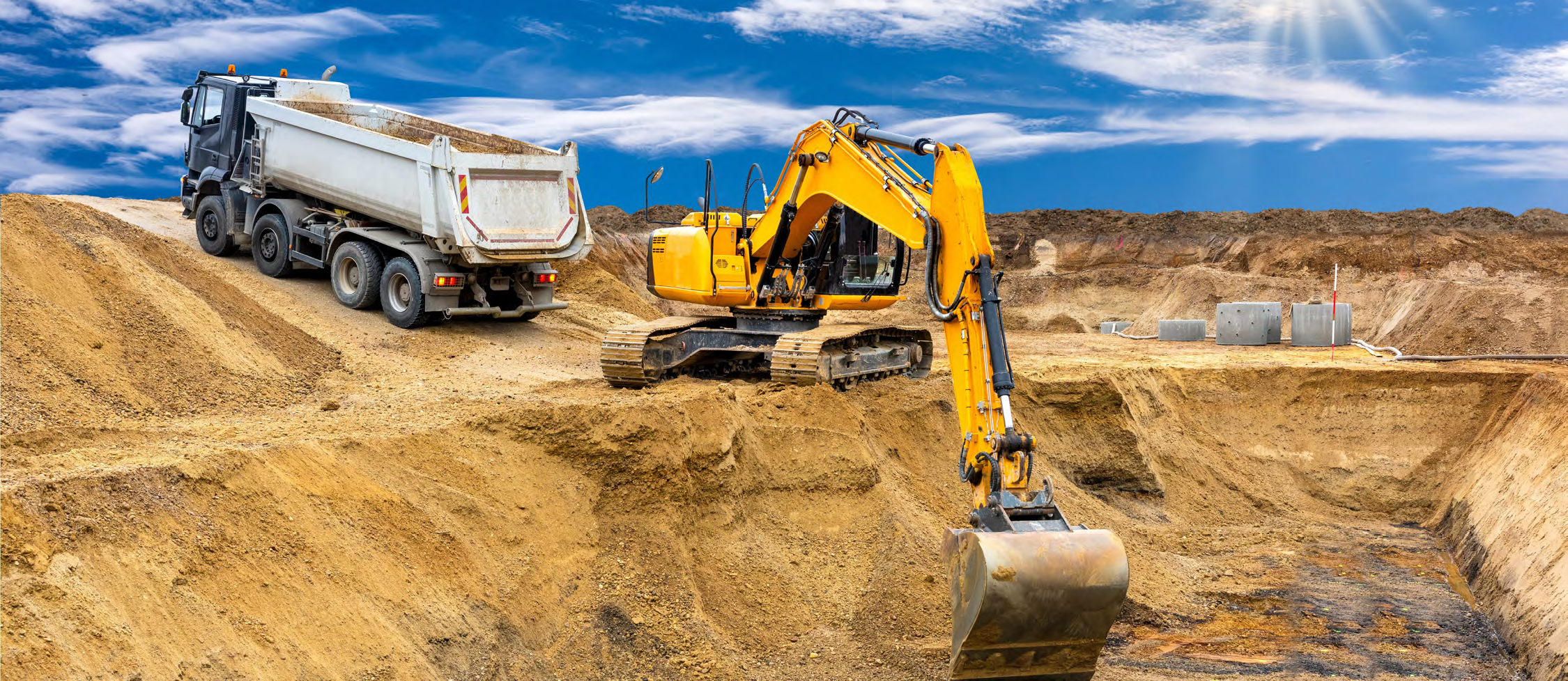 Construction and quarry workforce team standing in front of heavy excavation equipment